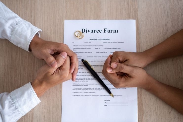 man and woman with their hands on an Arizona DIY divorce form